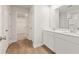 Modern bathroom features double sinks, white cabinetry and a closet at 2704 Mourning Dove Dr Lot 34, Grayson, GA 30017