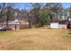 The backyard features green grass, a small wood deck, and trees in the background at 3645 Fay Dr, Rex, GA 30273