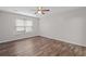 Bedroom with ceiling fan, natural light, and wood-look laminate flooring at 3645 Fay Dr, Rex, GA 30273