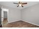 This bedroom features hardwood floors, a ceiling fan, and an open door at 3645 Fay Dr, Rex, GA 30273