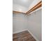 Walk-in closet has vinyl flooring and built-in wooden shelving at 3645 Fay Dr, Rex, GA 30273