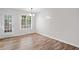 Bright dining area featuring wood floors and a window for natural lighting at 3645 Fay Dr, Rex, GA 30273