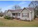 Attractive home showcasing a cozy front porch, gray siding, and a green lawn at 3645 Fay Dr, Rex, GA 30273