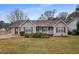 Charming home featuring gray siding, a brown roof, and well-maintained landscaping at 3645 Fay Dr, Rex, GA 30273