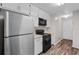 Efficient kitchen featuring stainless steel refrigerator and white cabinets offering a modern look at 3645 Fay Dr, Rex, GA 30273