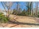 Lush backyard with mature trees offering privacy and shade, highlighting the natural beauty of the property at 45 Somerset Ct, Covington, GA 30016