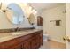 Bathroom featuring double sinks, granite countertops and wooden cabinets at 45 Somerset Ct, Covington, GA 30016