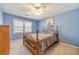 Bedroom features blue walls, carpet, ceiling fan and a bright window at 45 Somerset Ct, Covington, GA 30016