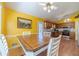 Bright dining area adjacent to kitchen, natural light, hardwood flooring and access to back patio at 45 Somerset Ct, Covington, GA 30016