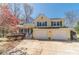 Beautiful yellow two-story home with blue shutters, front porch, and a spacious two-car garage at 45 Somerset Ct, Covington, GA 30016