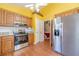 Bright kitchen featuring stainless steel appliances, wood cabinets, and laminate flooring at 45 Somerset Ct, Covington, GA 30016