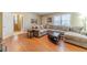 Living room with hard wood flooring and a sectional sofa; stairway visible in background at 45 Somerset Ct, Covington, GA 30016