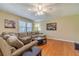 Inviting living room featuring hardwood floors, neutral paint, and a comfortable sectional sofa at 45 Somerset Ct, Covington, GA 30016