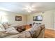 Comfortable living room featuring wood flooring, modern lighting, and a plush sectional sofa at 45 Somerset Ct, Covington, GA 30016