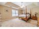 Main bedroom featuring tray ceiling, large windows, and neutral carpeting at 45 Somerset Ct, Covington, GA 30016