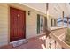 Charming front porch with a red door and wooden columns at 1312 Brandl Sw Dr, Marietta, GA 30008
