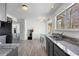 Modern kitchen features granite countertops, stainless steel appliances, and wood-look tile flooring at 1312 Brandl Sw Dr, Marietta, GA 30008
