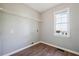 Practical laundry room with wood-look flooring, window, and a wire shelf at 4271 Weston Sw Dr, Lilburn, GA 30047