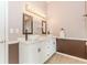 Bathroom with double sinks, tile floors, and decorative lighting at 775 Freeman Dr, Covington, GA 30016