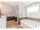Well-lit bathroom features a soaking tub and stylish vanity at 775 Freeman Dr, Covington, GA 30016