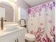 Stylish bathroom featuring a vessel sink, floral shower curtain, and white cabinets at 775 Freeman Dr, Covington, GA 30016