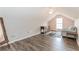 Cozy bonus room with wood floors, a comfortable seating area, and natural light at 775 Freeman Dr, Covington, GA 30016
