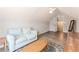 Bright bonus room with ample space, a blue couch, and a decorative area rug at 775 Freeman Dr, Covington, GA 30016