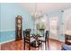 Dining area features wood floors, natural light from the back yard, and a glass top table at 775 Freeman Dr, Covington, GA 30016
