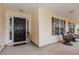 Inviting front porch with decorative columns and ample seating with mature shrubbery at 775 Freeman Dr, Covington, GA 30016