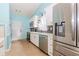 Modern kitchen features white cabinets, stainless steel appliances, and ceramic flooring at 775 Freeman Dr, Covington, GA 30016