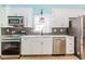 Modern kitchen with stainless steel appliances, ample cabinet space and designer backsplash at 775 Freeman Dr, Covington, GA 30016