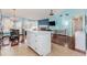 Open-concept kitchen features an island, tile floor, and view of the dining area and fireplace at 775 Freeman Dr, Covington, GA 30016