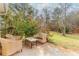 Outdoor patio with wicker furniture, surrounded by lush greenery and trees at 775 Freeman Dr, Covington, GA 30016