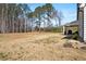 Sprawling backyard featuring an expansive lawn and covered patio, ideal for outdoor activities and relaxation at 844 Pool Rd, Hiram, GA 30141