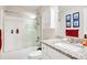 Bathroom featuring a shower-tub combination with glass doors, granite countertop, and bright lighting at 844 Pool Rd, Hiram, GA 30141