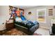 Bedroom featuring a large bed, decorative anime mural, and a bright window at 844 Pool Rd, Hiram, GA 30141