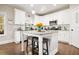 Bright kitchen featuring white cabinets, granite countertops, and a center island with seating at 844 Pool Rd, Hiram, GA 30141