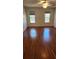 Bright bedroom showcasing hardwood floors, windows that provide natural light, and ceiling fan at 985 Lake Haven Ct, Roswell, GA 30076