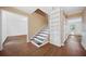 Foyer featuring hardwood floors, a staircase, and a built-in bookshelf at 985 Lake Haven Ct, Roswell, GA 30076