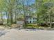 Charming two-story home with a two-car garage, blue shutters, and mature trees in a peaceful setting at 985 Lake Haven Ct, Roswell, GA 30076