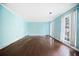 Spacious living room featuring hardwood floors, light blue walls, large windows, and bright natural light at 985 Lake Haven Ct, Roswell, GA 30076