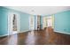 Bright living room boasts hardwood floors, fresh light blue paint, built-in shelving, and large bright windows at 985 Lake Haven Ct, Roswell, GA 30076