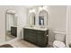 Stylish bathroom featuring a double vanity, modern arched mirrors, and a toilet at 2901 Lenox Rd # 1002, Atlanta, GA 30324