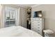 Bedroom showcasing a white dresser with a TV and a collection of stylish hats atop at 2901 Lenox Rd # 1002, Atlanta, GA 30324