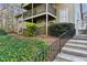 Exterior view of a two-story home with balconies, green siding and landscaping at 2901 Lenox Rd # 1002, Atlanta, GA 30324