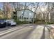 Exterior showing a multi-story home with parking in front and lush landscaping at 2901 Lenox Rd # 1002, Atlanta, GA 30324