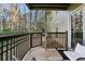 Charming covered patio with railing and views of the surrounding greenery, featuring seating at 2901 Lenox Rd # 1002, Atlanta, GA 30324