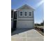 New construction with a two-car garage, neutral siding, and a concrete driveway in a suburban setting at 5185 Longview Run, Decatur, GA 30035