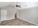 Spacious bedroom features wood floors, a ceiling fan, and an ensuite door at 2897 Austin Common Dr, Dacula, GA 30019