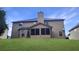 Back exterior of a house with a well-kept lawn and a screened-in porch, creating a private outdoor space at 2897 Austin Common Dr, Dacula, GA 30019